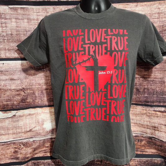 Gray t-shirt with red graphic and text on a wooden surface
