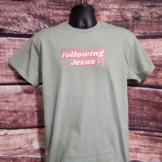 Mint t-shirt with pink text on a wooden surface Background.