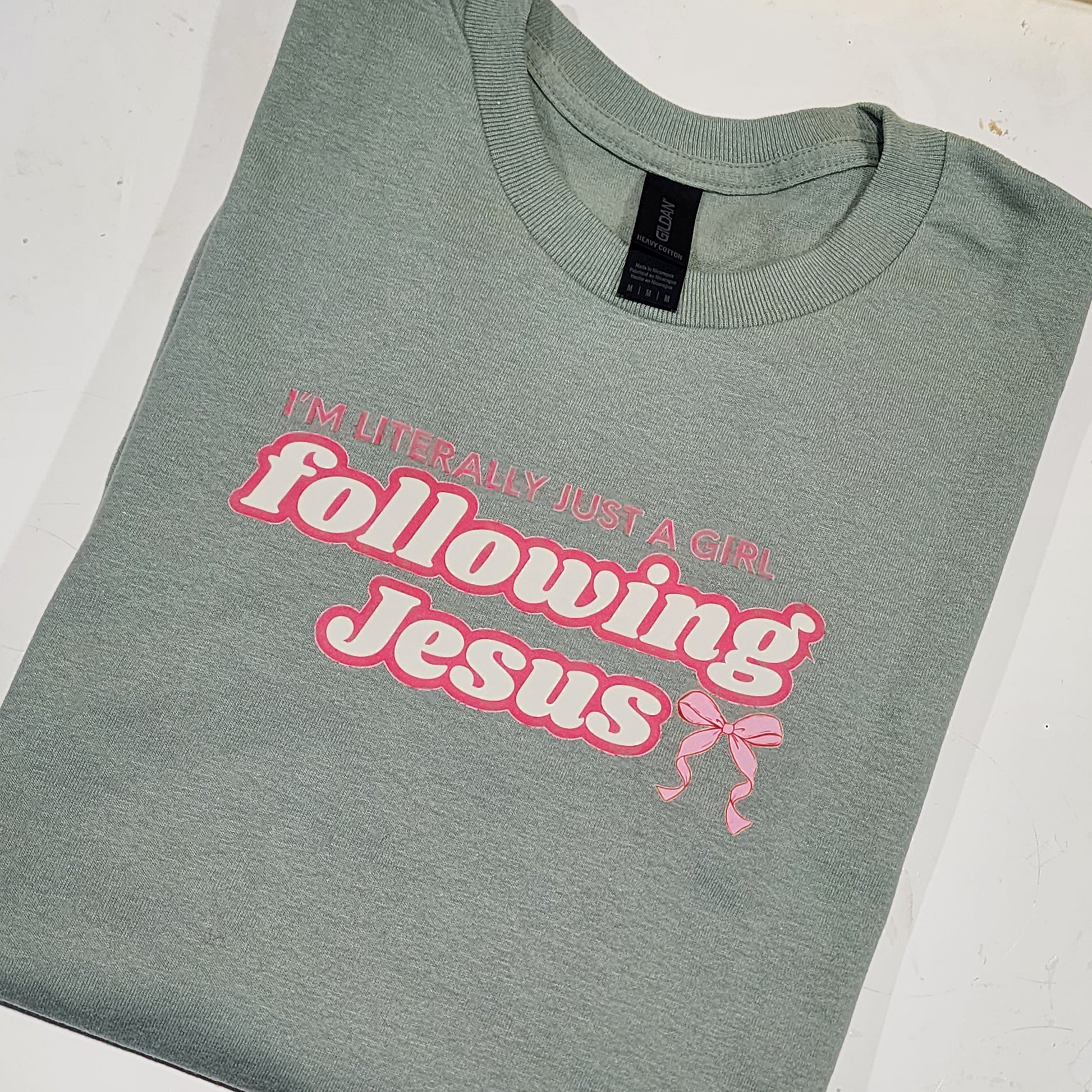 Mint Green t-shirt with pink text and graphics on a white background