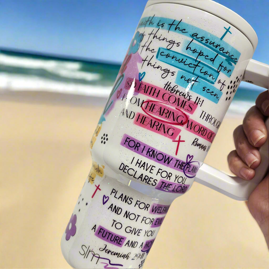 tumbler with bible verses being held